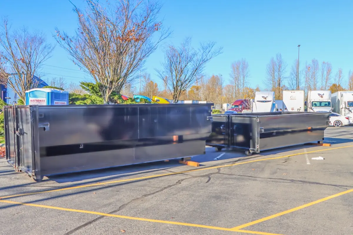 Professional dumpster rental service with roll-off container on residential driveway in Panthersville